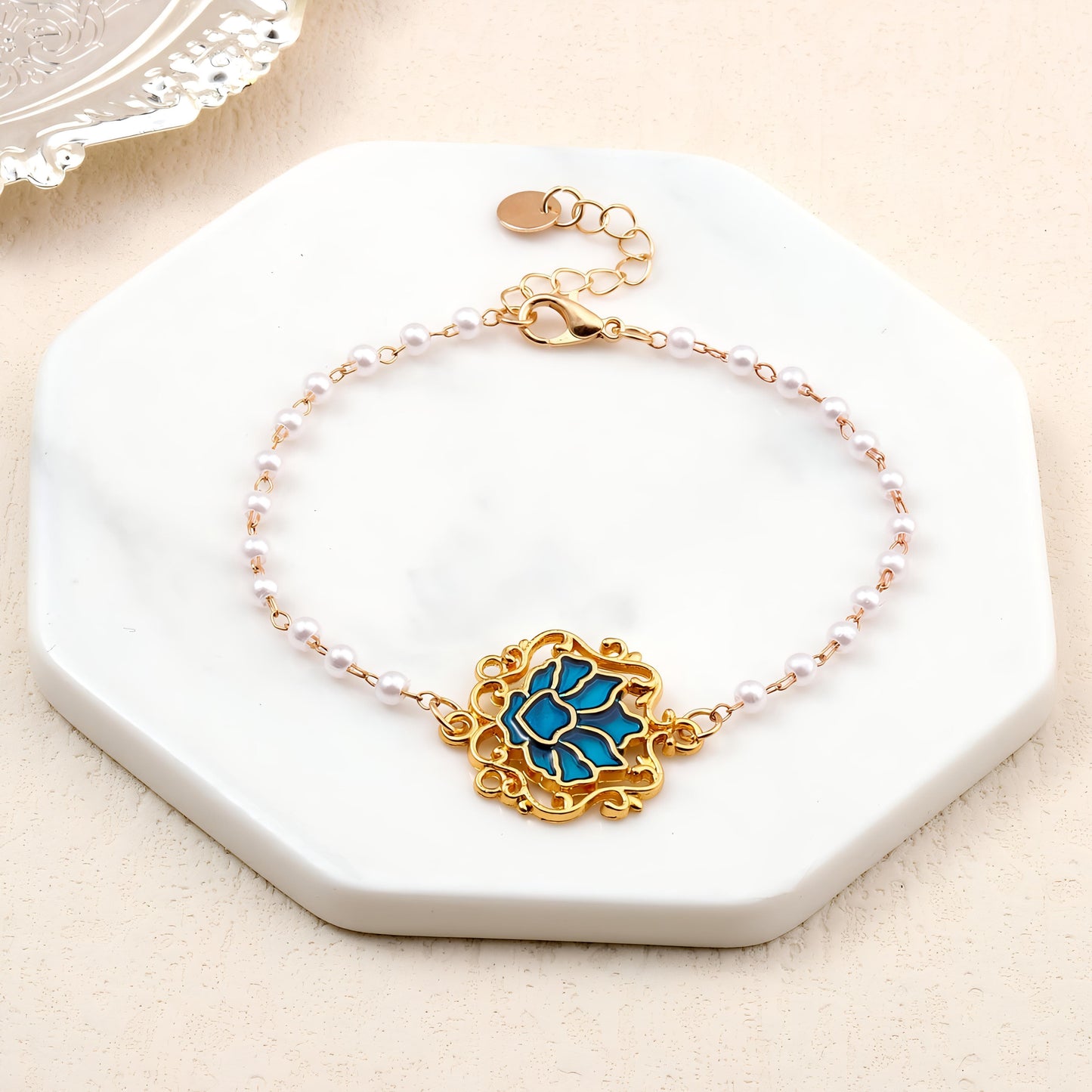 Serenity Lotus Blue Charm Gold Bracelet by Gleamy